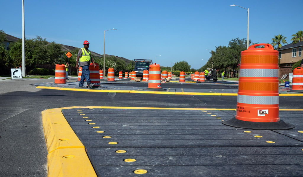 Road markings in front of a construction worker on a street.