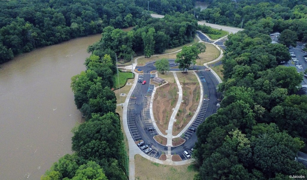 A bird’s eye view of a park along a river.