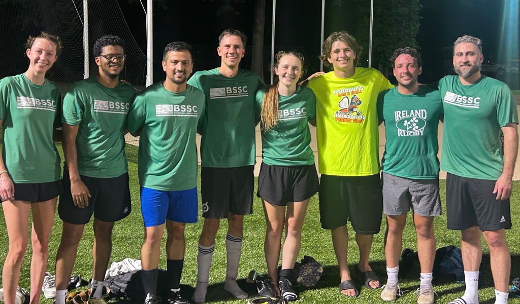 A group of young adults after a soccer game.