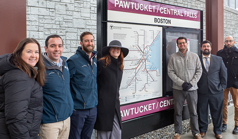 Group of people standing in front of a railroad map.