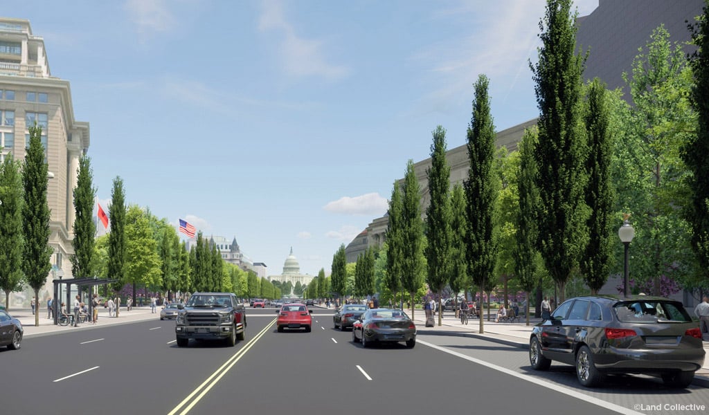 Tree-lined urban boulevard with multiple lanes of traffic leading toward the U.S. Capitol.