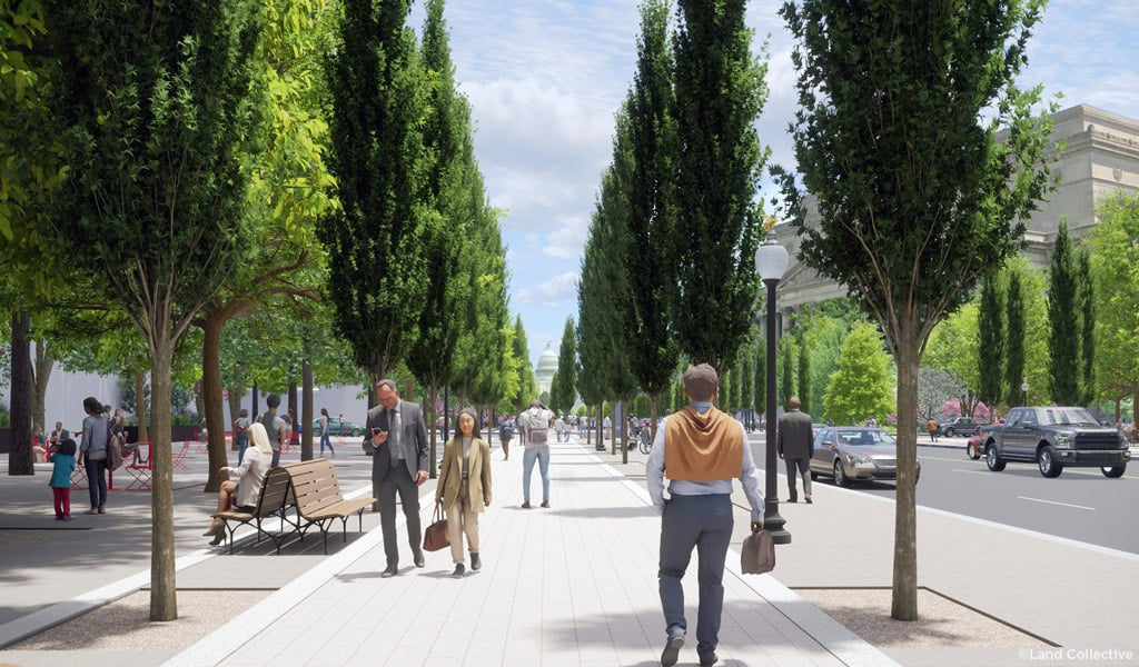 Active pedestrian promenade lined with tall trees, benches, and seating areas, with people walking.