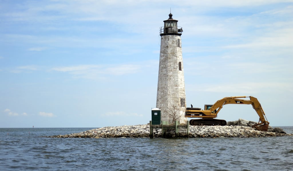 Lighthouse with construction equipment.