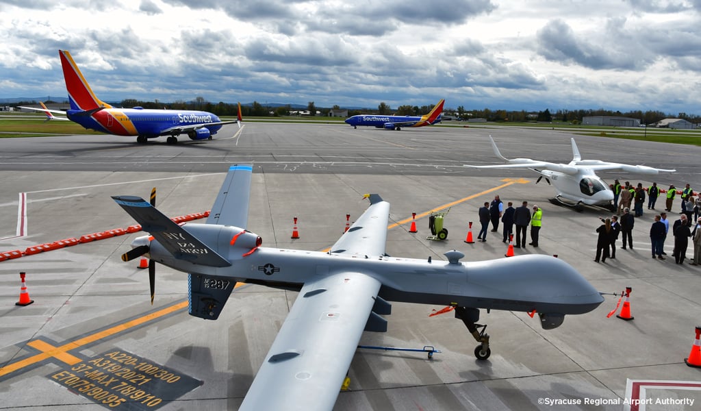 A group of airplanes on a runway. 