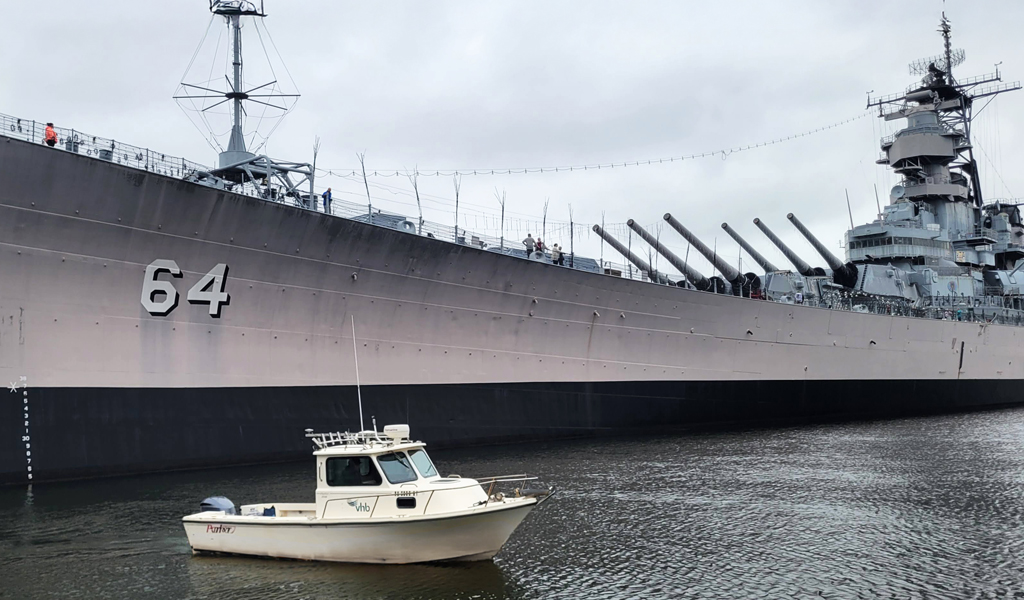 VHB’s vessel floats proudly beside the USS Wisconsin in Norfolk’s harbor.