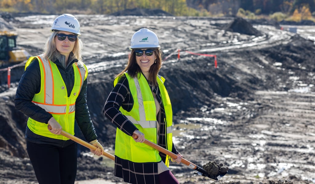 Two women in protective gear at a groundbreaking.