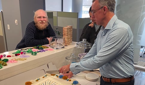 Joe Wanat cuts the cake at the Tysons office.