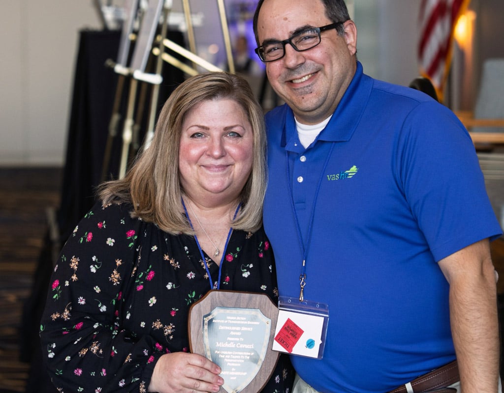 Michelle Cavucci stands with VASITE President, Jeff Kuttesch, and poses with her award. 