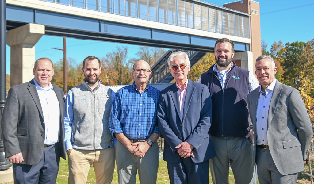 The VHB team stands together in front of the project for a group photo. 