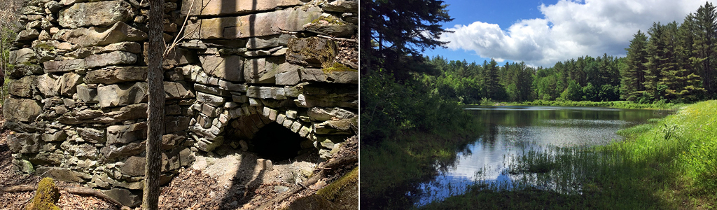 Stone structure with arched opening surrounded by forest trees and fallen leaves and Tranquil Reservoir bordered by lush green trees under a blue sky with fluffy white clouds.