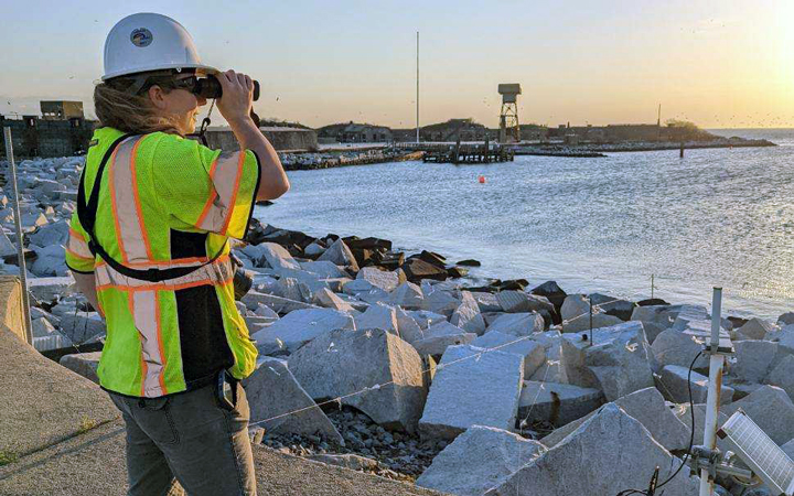 Anna Weaver performs bird monitoring duties during an evening site visit on South Island. 