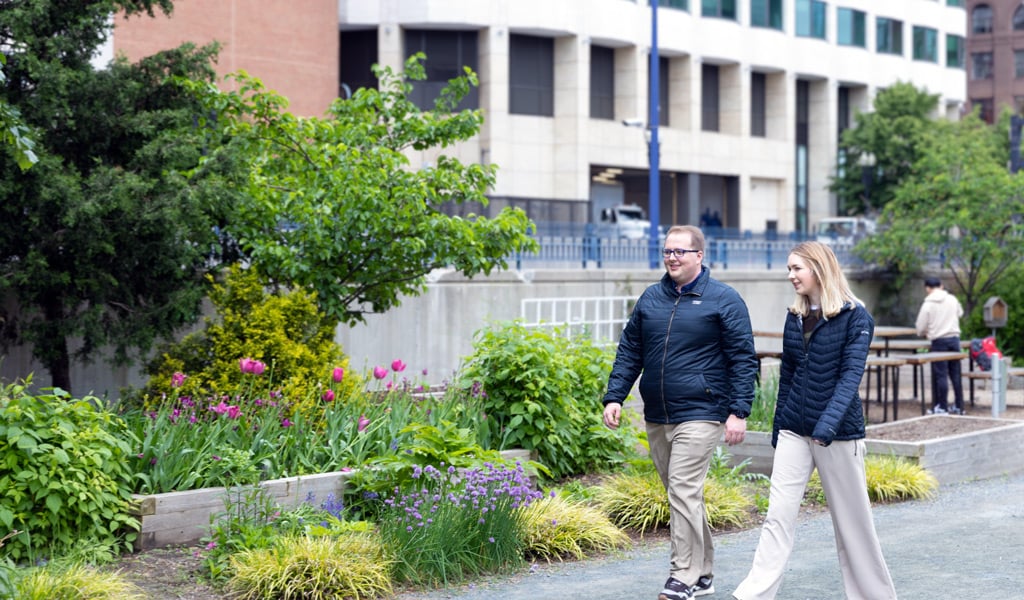 Gavin Graham and a teammate walking through downtown Boston during a collaborative discussion.