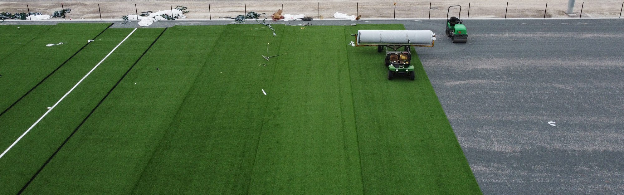 Aerial view of the new turf being installed on the soccer fields.