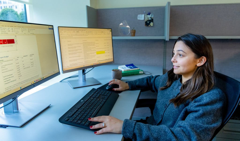 Lindsey Cassone working at her desk in VHB's NYC office.