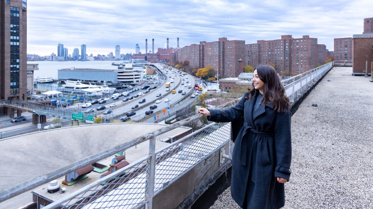 Lindsey Cassone on the roof of the CUNY Hunter College Brookdale campus overlooking the New York City skyline.