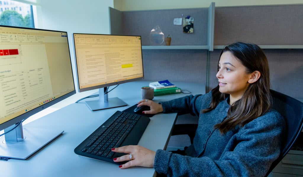 Lindsey Cassone working at her desk in VHB's NYC office.