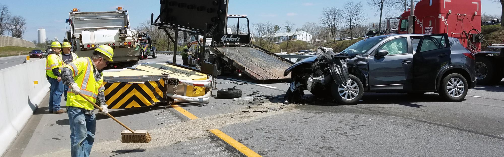 First responders clear a roadway crash scene and restore safe traffic flow.