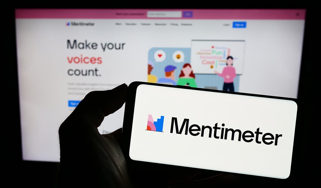 Attendees use phones to respond to live poll questions during a public meeting.