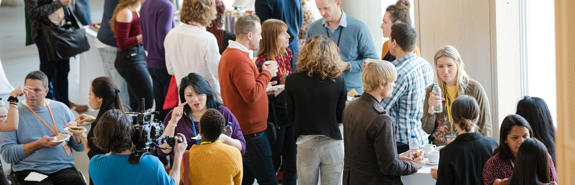 A group of community members in a meeting hall.
