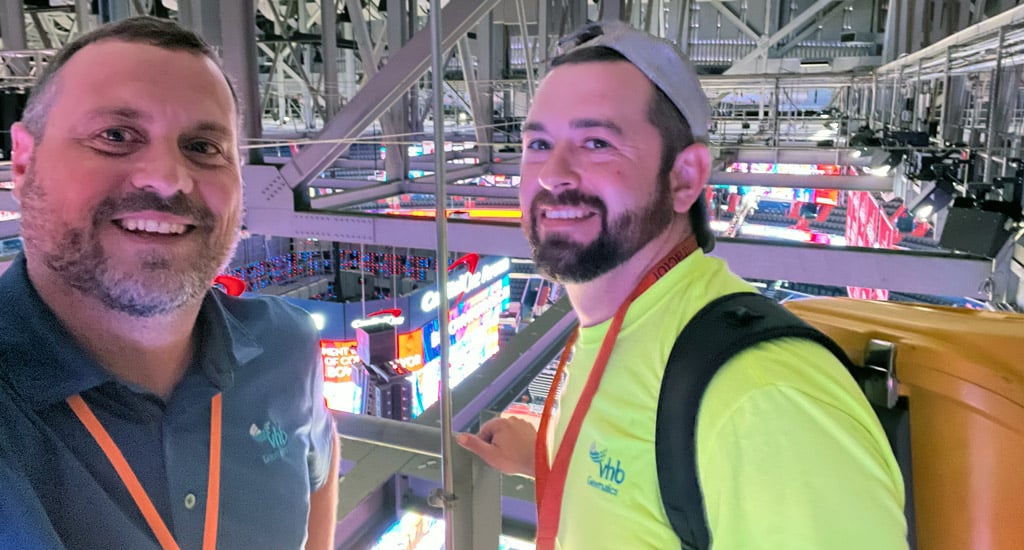 Shaun (left) and Patrick Atkins (right) establishing control points from the catwalk of a DC sports and entertainment venue.