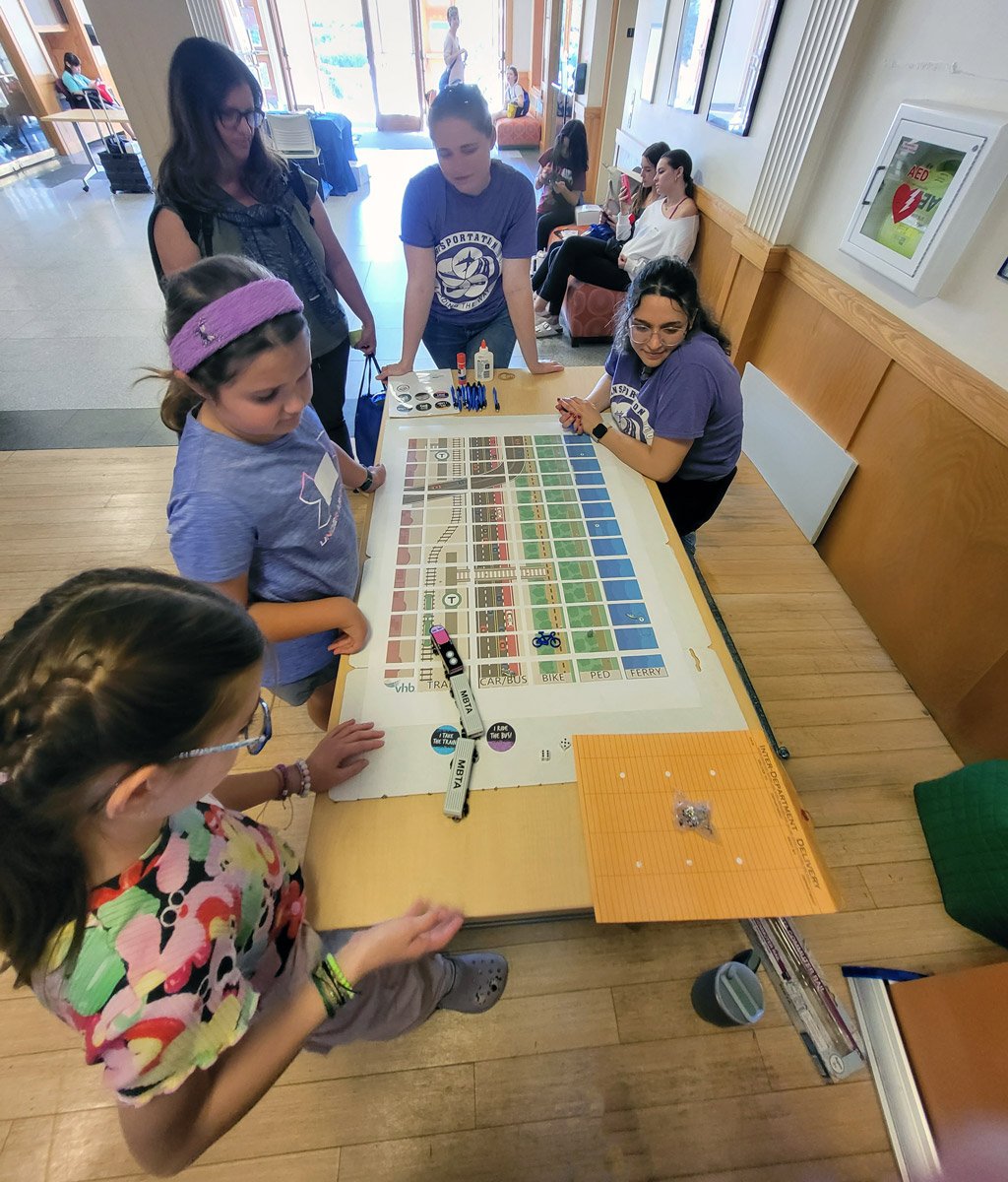 Kids play a transportation activity at the WTS-Boston Transportation YOU Summit