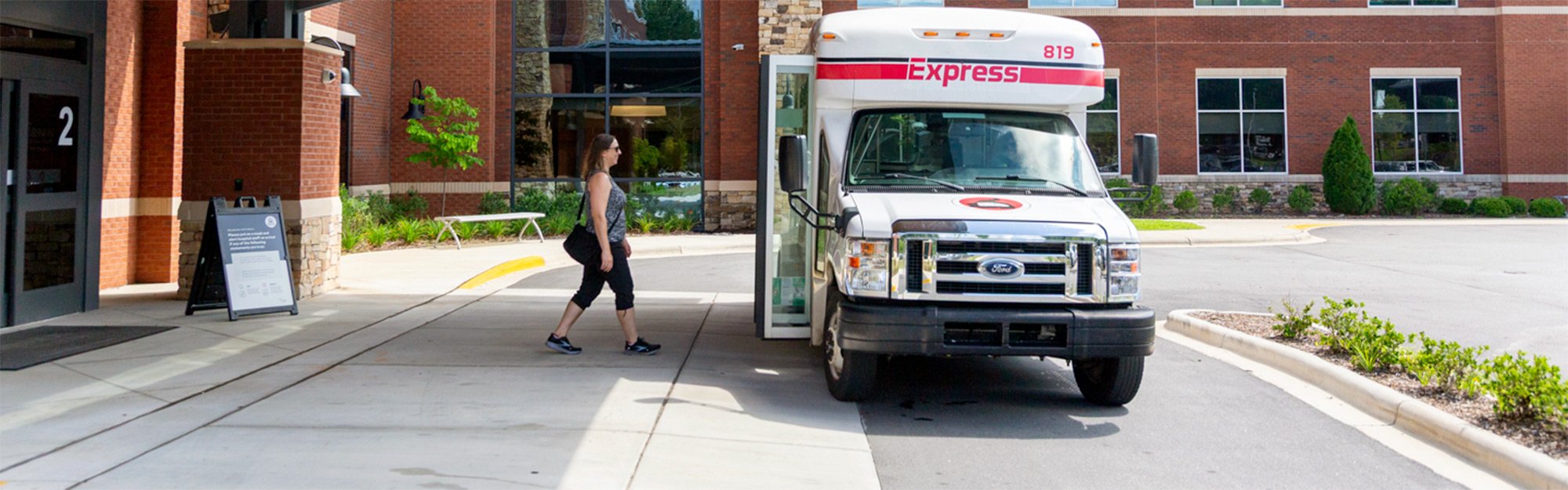 A rider boards the MEE microtransit service, providing on-demand, door-to-door trips within a defined service area.