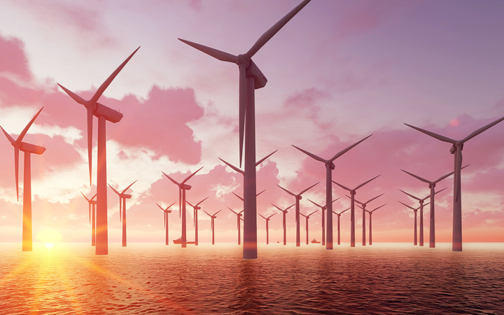 A sea of wind turbines at sunset