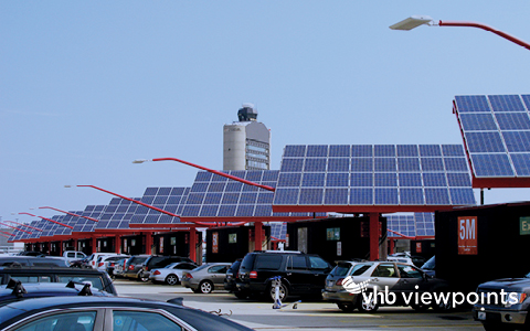 Solar panels are incorporated as part of an airport parking facility.