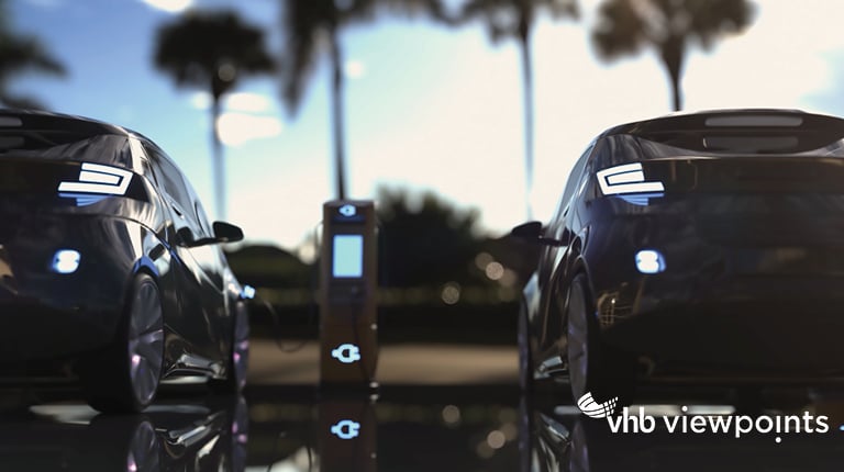 Electric vehicles parked at charging station.