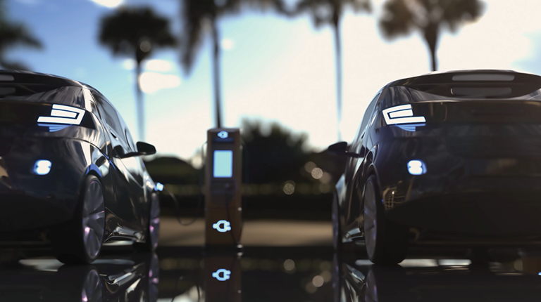 Electric vehicles parked at charging station.