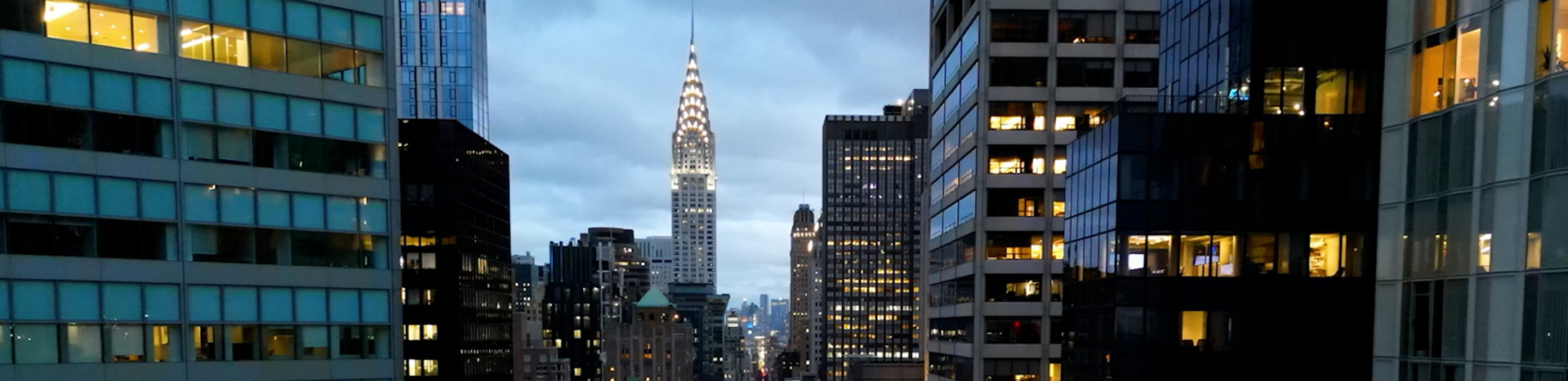 Panning down New York City office buildings at dusk.