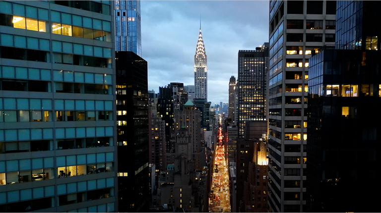 Panning down New York City office buildings at dusk.