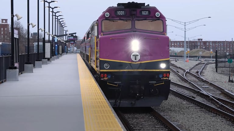 An MBTA commuter rail train entering a station on South Coast Rail.
