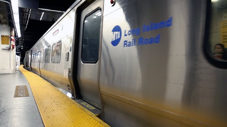 A subway train pulling into an underground station platform.