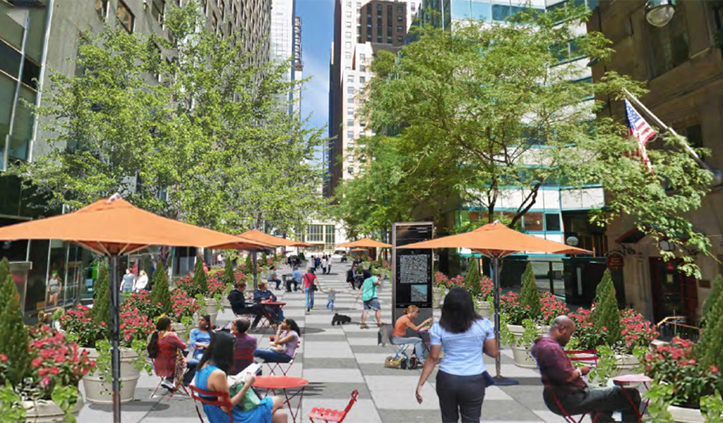 A downtown plaza with outdoor seating and space for pedestrians.