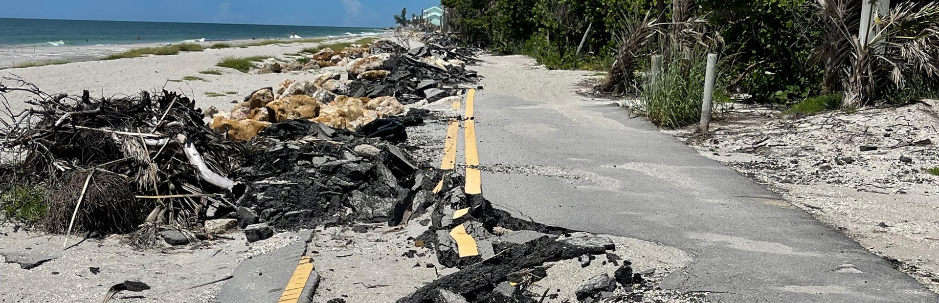 A destroyed street and park on a beachfront.