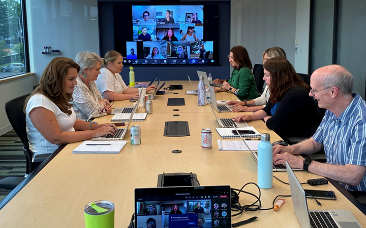 VHB team members conduct a hybrid meeting, with some in-person and some participating on screen