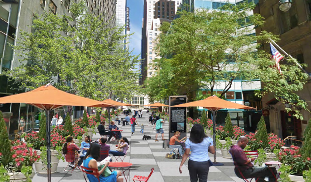 A downtown plaza with outdoor seating and space for pedestrians.