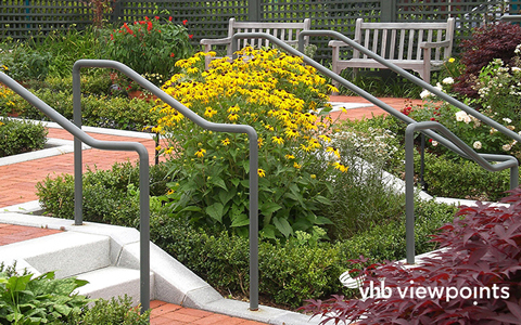 Outdoor garden with robust flowere, brick walkways, and benches.